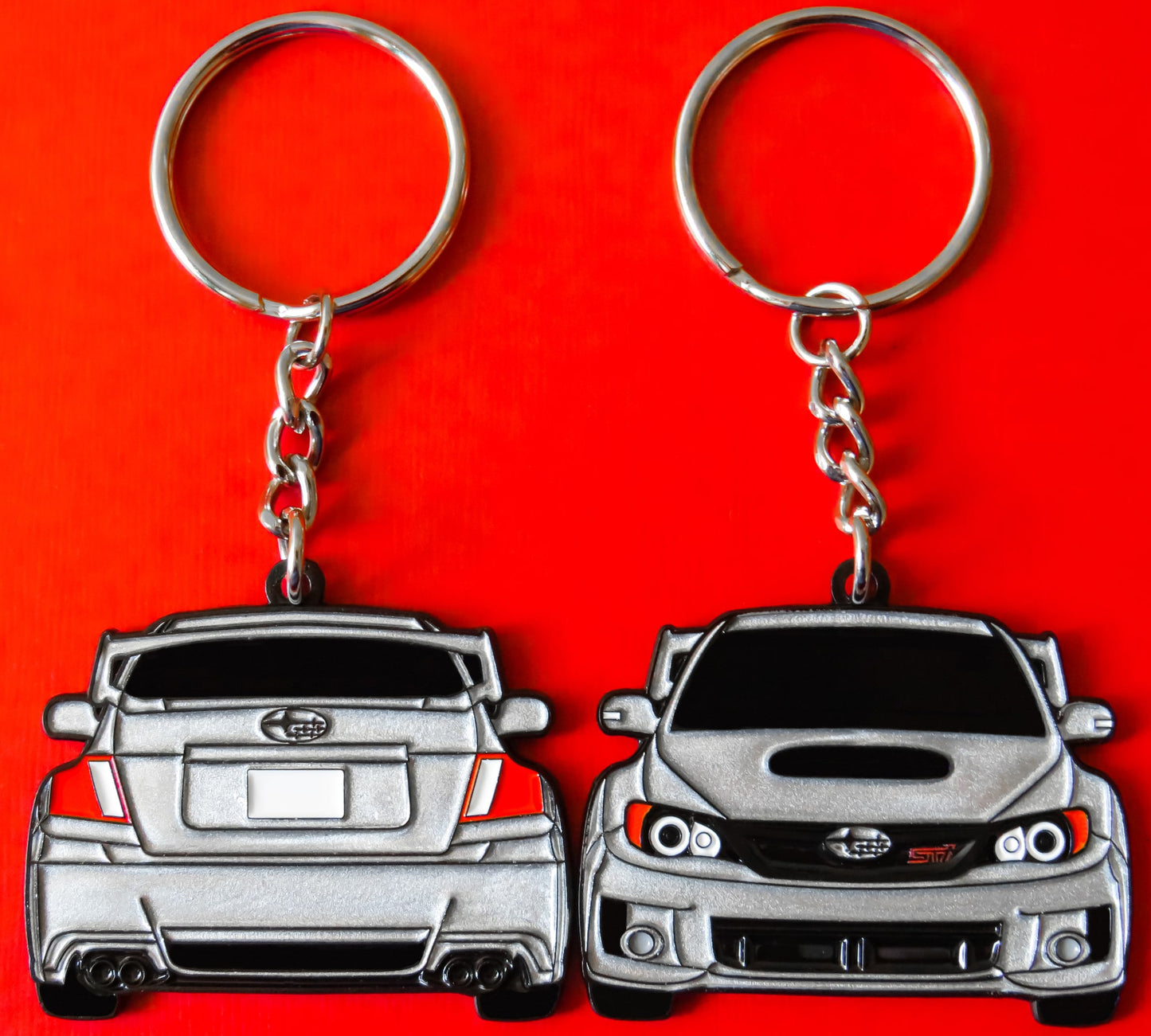 Silver Subaru WRX STI 2-Sided Keychain that fits on a key fob, Precision-Crafted Design, Ideal for WRX STI Enthusiasts, Rally Car Lovers, and Automotive Fans. Elevate Your Keys with WRX STI Style and Unmatched Performance, A Must-Have Accessory for Subaru WRX STI Owners. A great gift for owners, fans, him, her, boyfriend, girlfriend, mom, dad, father, mother, and more!