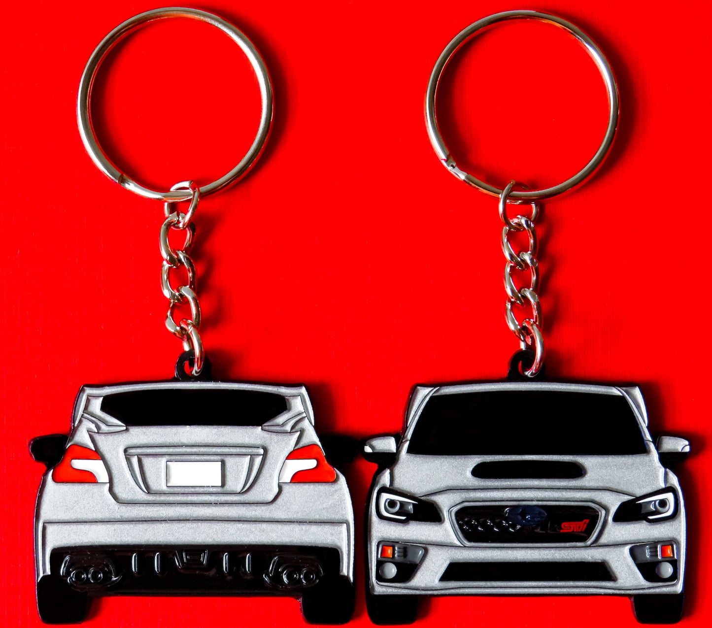 Silver Subaru WRX STI 2-Sided Keychain that fits on a key fob, Precision-Crafted Design, Ideal for WRX STI Enthusiasts, Rally Car Lovers, and Automotive Fans. Elevate Your Keys with WRX STI Style and Unmatched Performance, A Must-Have Accessory for Subaru WRX STI Owners. A great gift for owners, fans, him, her, boyfriend, girlfriend, mom, dad, father, mother, and more!